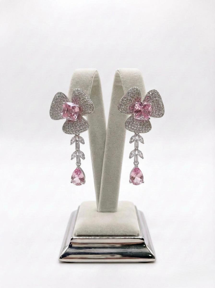  Detailed view of the petal-inspired hot pink American Diamond jewelry, highlighting the shimmering pavé setting and teardrop crystal finish.