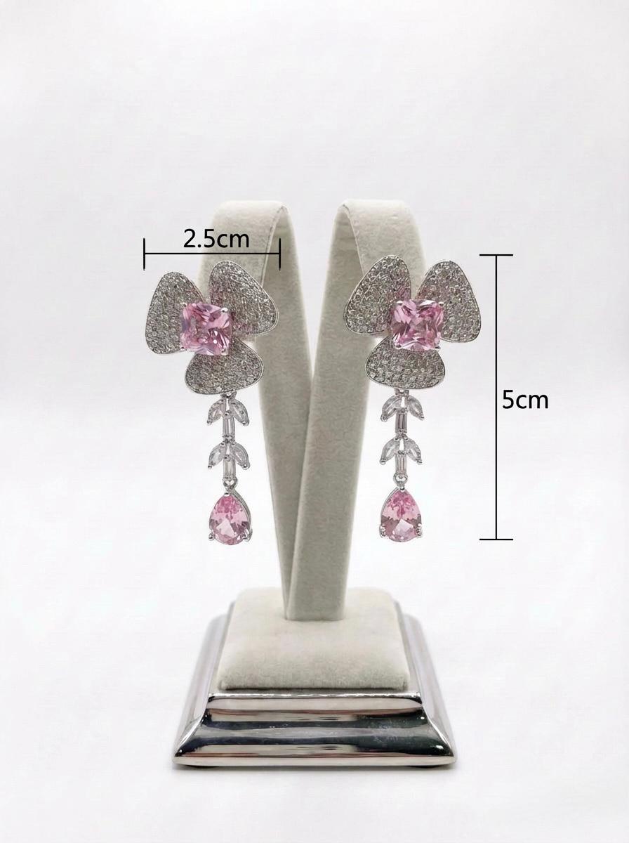  Detailed view of the petal-inspired pink American Diamond jewelry, highlighting the shimmering pavé setting and teardrop crystal finish.