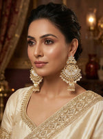 Detailed view of traditional gold-toned crescent-shaped earrings with a 9cm drop length and 5cm width.