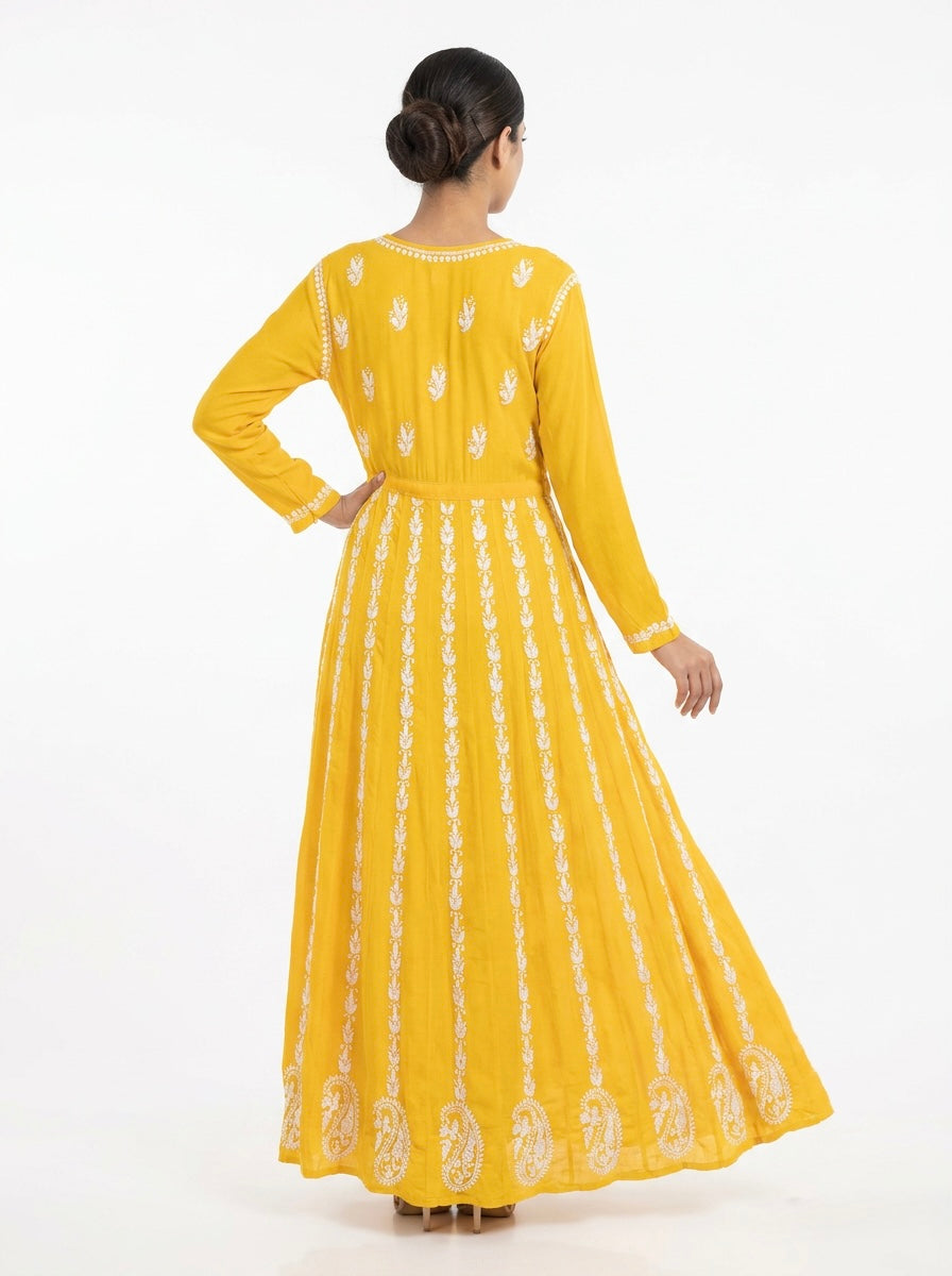 A Model is showing the rear view of this Yellow chikankari hand embroidered Aanarkali long dress.