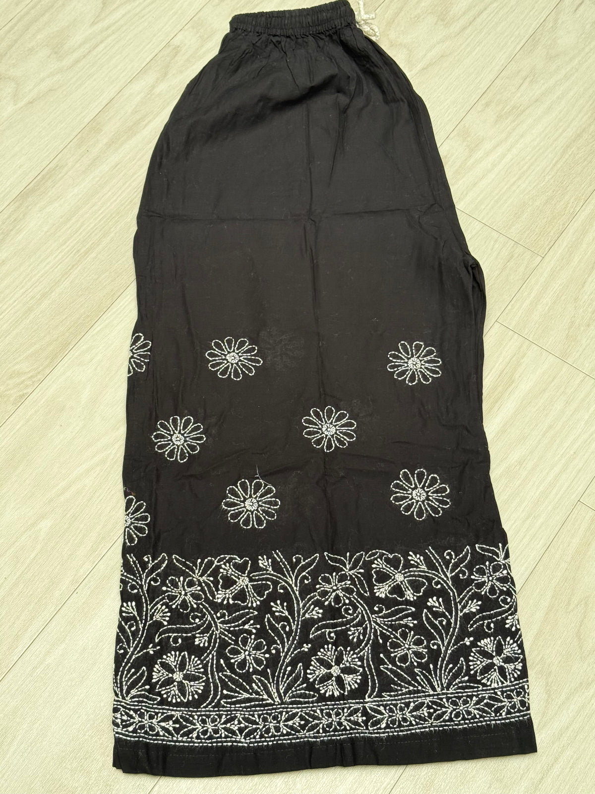 Elastic waistband of black cotton flared pants – stretches 28 to 48 inches