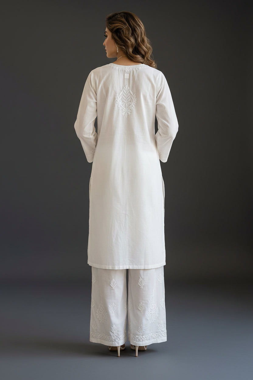 Back view of a white Chikankari co-ord set, showing delicate embroidery motif on the upper back and detailed craftsmanship on the plazo pants.