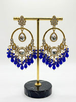 Elegant ethnic statement earrings in rose gold finish with sapphire blue accents, perfect for formal occasions.
