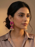 Elegant model styling 5.5cm hot pink Meenakari jhumkas with a classic bell-shaped drop and pearl finish.
