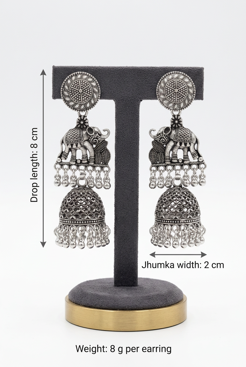 Royal Parade silver-toned elephant jhumka earrings on a stand with annotations showing 8 cm drop length, 2 cm width, and 8 g weight