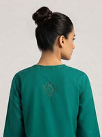 Back view of a model wearing a vibrant green short kurti, highlighting subtle tonal embroidery along the upper back neckline and a small centered floral motif on the upper back.