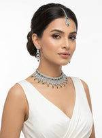 Bridal American Diamond Choker Set with Emerald Green teardrop stones, including matching earrings and maang tikka, worn by a model against a white background.