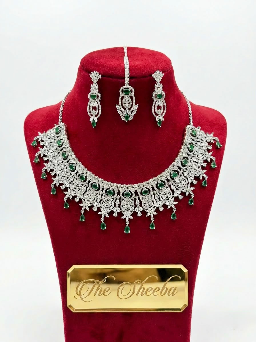 Silver plated bridal necklace set with emerald green stones, cubic zirconia, matching earrings and maang tikka – The Sheeba"