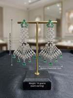 Regal emerald green and American Diamond grand bridal earrings in a traditional yet contemporary long drop design for weddings and formal evening wear.