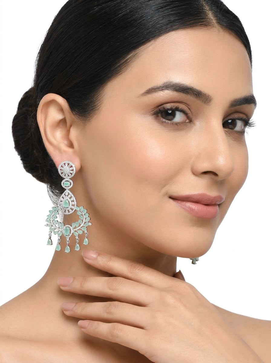 Model wearing Ethereal Aqua Mist drop statement earrings featuring intricate rhodium-plated detailing and soft aqua stone accents.