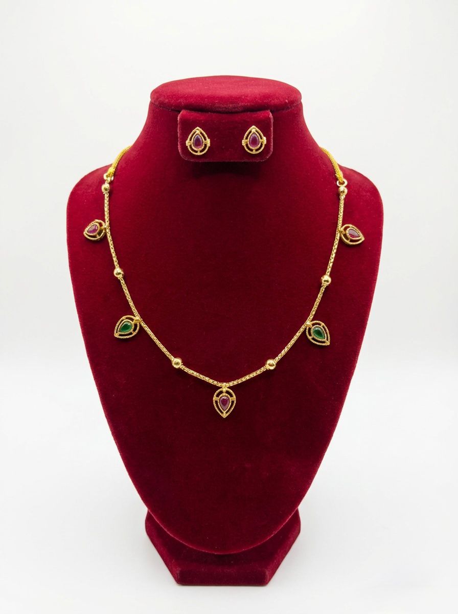 Exclusive one-of-a-kind multicoloured Minakari necklace and stud earrings set displayed on a professional jewellery stand.