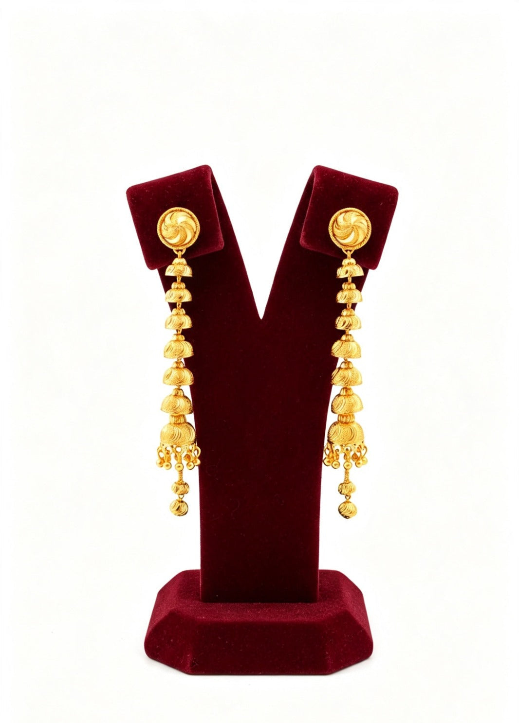 a pair of gold plated 7cm drop length earrings displayed on a stand