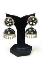 Black mirror bead jhumka earrings — jet black micro-beadwork, multi-tone mirror inlays, silver-toned bead border & hanging ghungroos, displayed on black velvet stand against white — Famaza Couture.