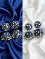 Pair of cobalt blue multi-mirror bead jhumka earrings — left on royal blue satin, right on white silk; oxidized silver finish, mixed gold/silver mirror inlays, hanging ghungroos — Famaza Couture ethnic bridal jewelry.