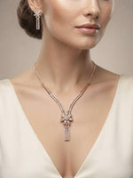 A close-up view of a model wearing a rose gold necklace and matching earrings featuring intricate floral zircon detailing, designed for an elegant and refined look.