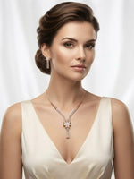 A model wearing the Famaza Couture signature dainty floral zircon necklace and matching floral stud earrings in a luxurious rose gold finish, styled for a sophisticated and elegant look.