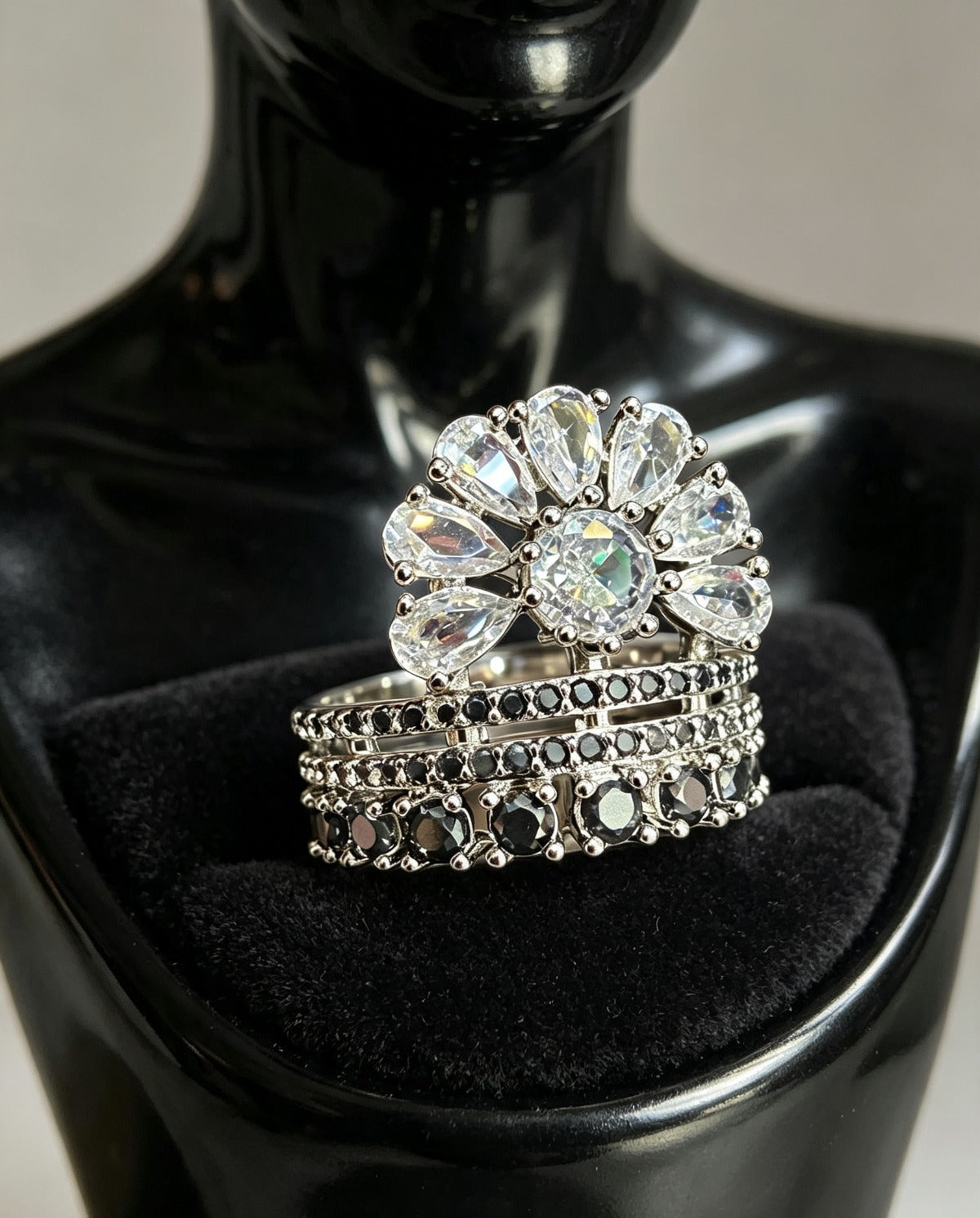 Fan Halo Tiered Ring with white crystal fan halo and silver & black multi-tiered band, luxury designer jewelry displayed on elegant black jewelry stand