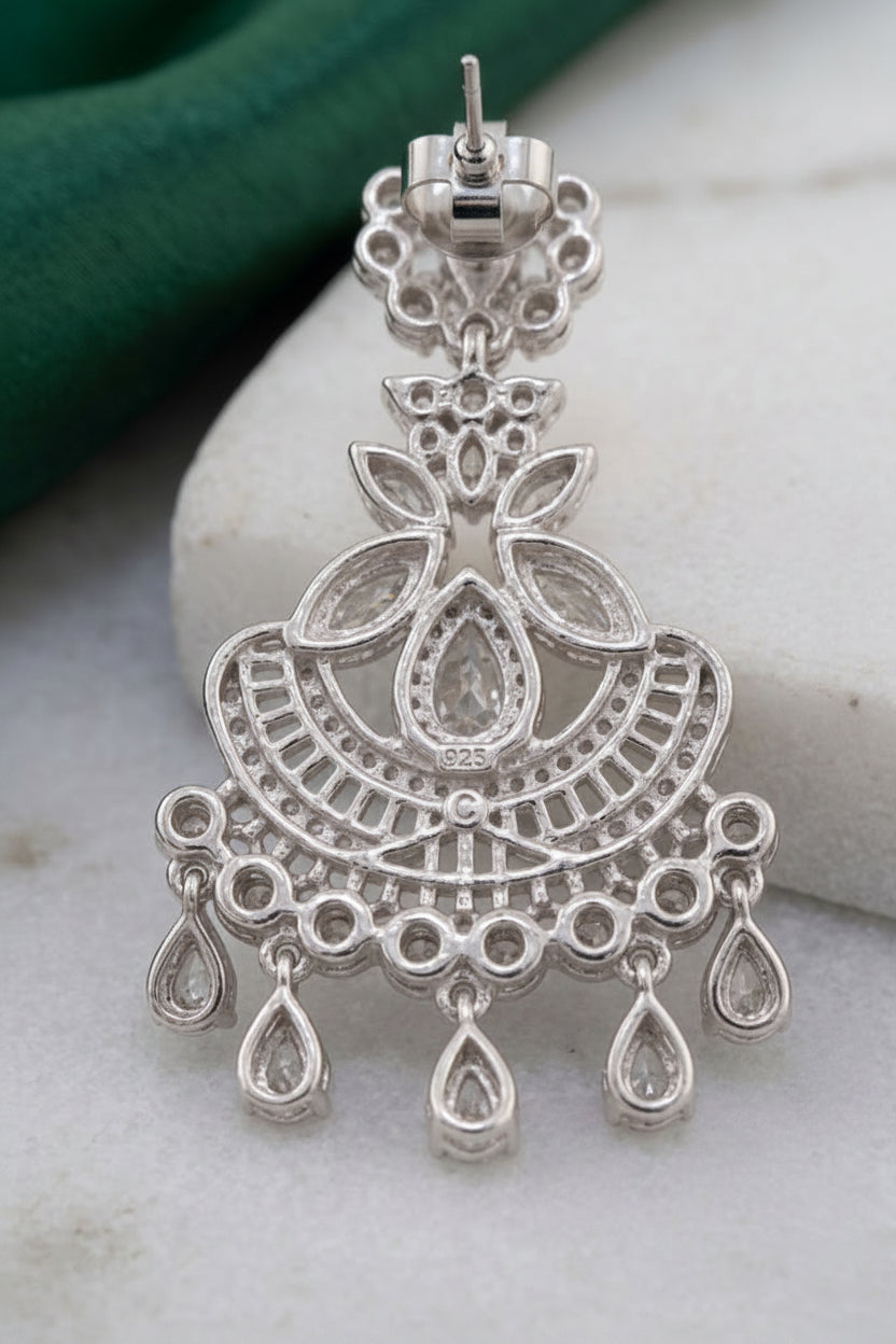 Elegant silver crystal chandelier earring showing the post and clear rubber stopper design, placed next to additional replacement earring backs."
