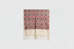 Floral patterned scarf with fringe on a light gray background