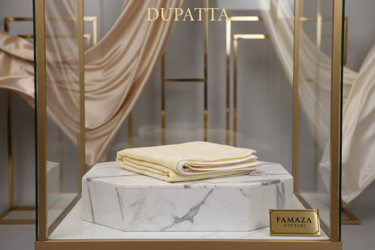 Folded fabric on a marble stand with 'FAMAZA' branding in a decorative setting.