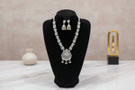 Full view of the artisan mirror-work long necklace and jhumka set displayed on a black velvet jewelry bust.
