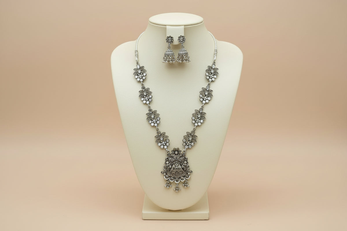 Full view of the artisan mirror-work long necklace and jhumka set displayed on a jewelry bust.