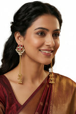 Ghungru jhumkas adorned with maroon crystal accents and white teardrop droplets.
