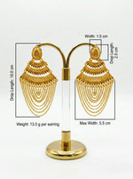 Gold earrings on a stand with measurements displayed.