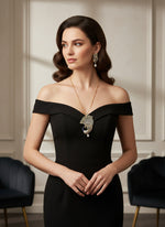 Gold plated a set of peacock-shaped pendant in gold chain with peacock-shaped earrings. The pendant is detailed with green, blue, and gold enamel and has sparkling crystal embellishments.