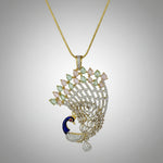 Gold plated peacock-shaped pendant in gold chain The pendant is detailed with blue, and gold enamel and has sparkling crystal embellishments.