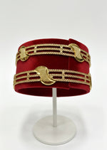 Gold bracelet on a white stand against a white background