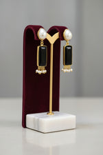 Gold polished earrings with vibrant Black stone and white baroque pearl in the top stud. 