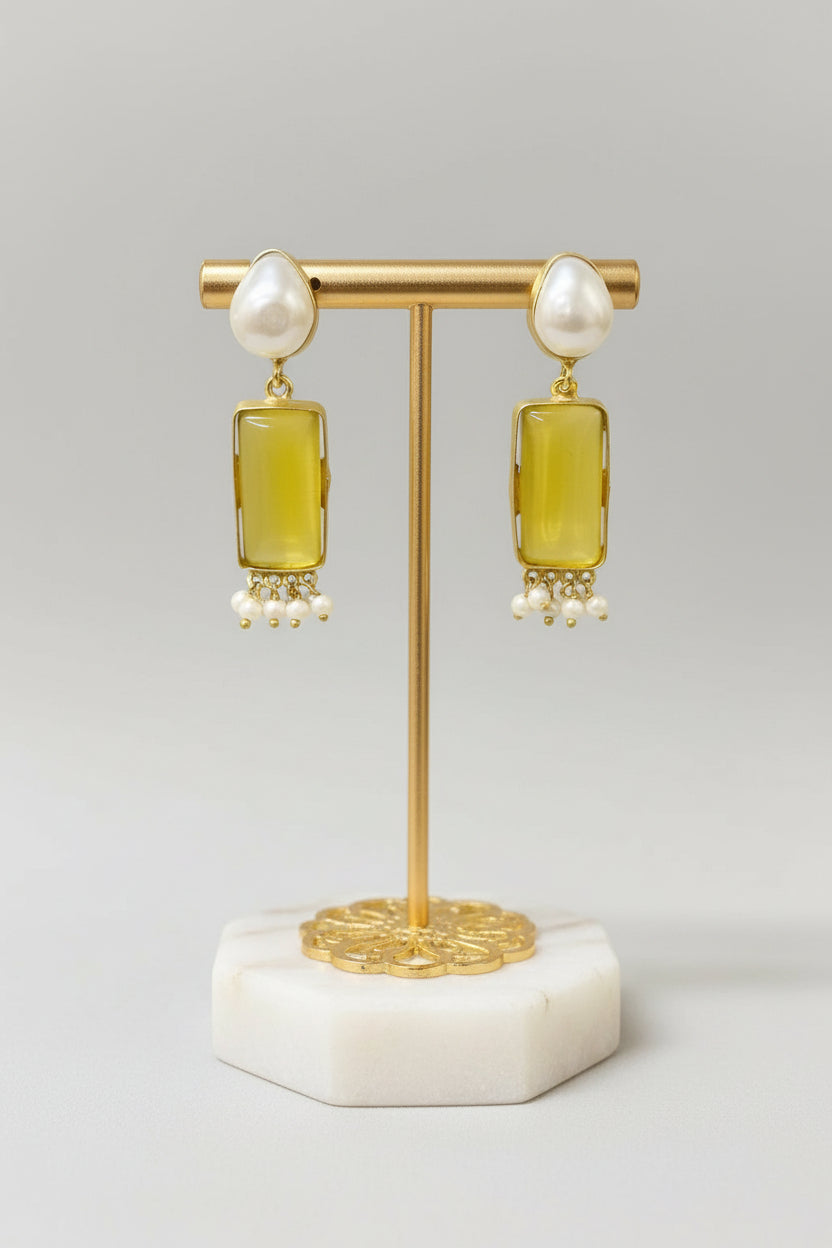 Gold polished earrings with vibrant yellow stone and white baroque pearl in the top stud. 