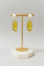 Gold polished earrings with vibrant yellow stone and white baroque pearl in the top stud. 