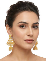 Model wearing large three-tier fan-shaped gold-plated jhumka earrings featuring intricate filigree work and a bell-shaped drop.