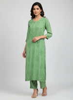 Green colour modal fabric long kurti and trousers with hand embroidery.
