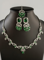Green gemstone necklace and earrings on a black mannequin by famaza couture 