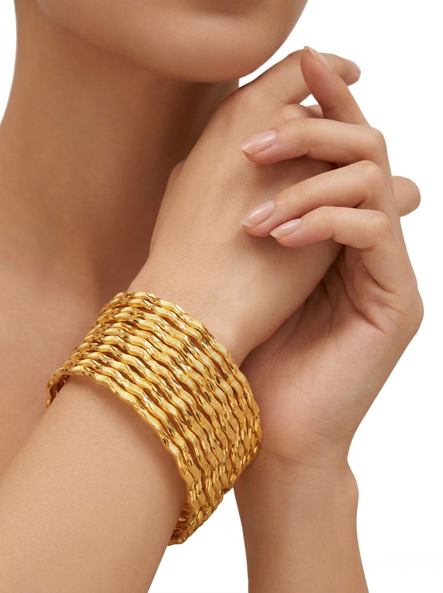 A close-up lifestyle shot of a woman's wrist wearing a set of eight micro gold-plated bangles with a textured, wavy design. Her hands are elegantly clasped near her face against a soft, neutral background.