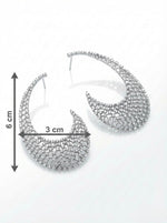 detailed shot of elegant diamond 'The Gilded Lattice' statement earrings displayed on a model in profile.