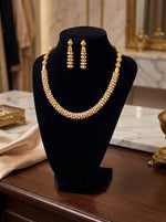 High-detail shot of the white nano pearl bead choker set displayed on a premium black velvet jewellery stand.
