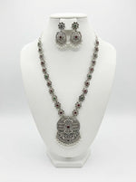 High-grade silver oxidised medallion necklace set with matching earrings on a display stand, showcasing the premium alloy craftsmanship and antique polish.