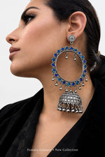 Model wearing blue and teal enamel-painted silver-tone hoop jhumka earrings