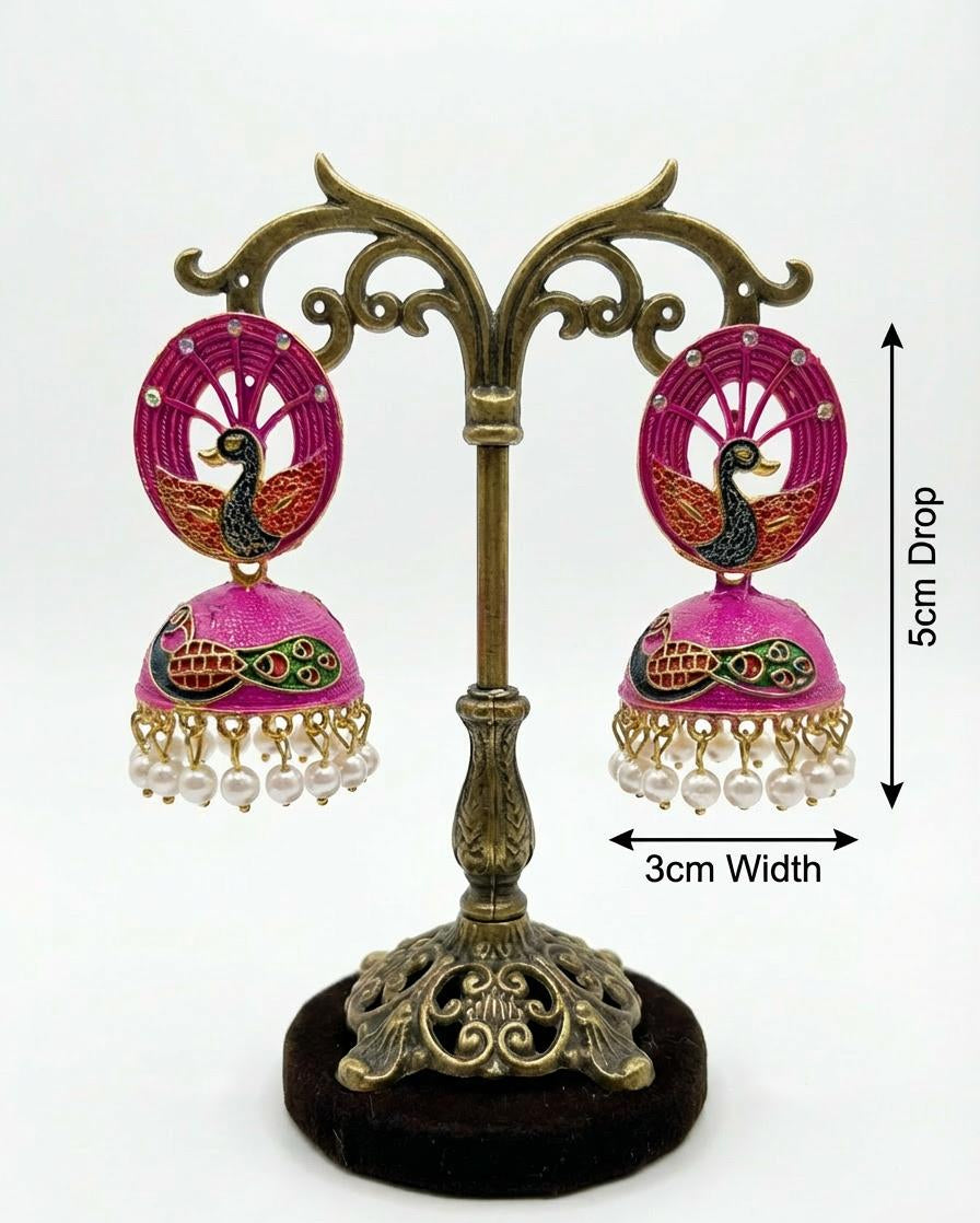 Hot pink 5.5cm peacock jhumka earrings displayed on a dark velvet card highlighting the 3cm width.