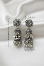 Detailed size chart of oxidized silver jhumka earrings: peacock‑embellished top stud (1cm width), total drop length 6cm, bottom jhumka width 2cm, with multi‑layered bell design and dangling bead accents on a plain white background.