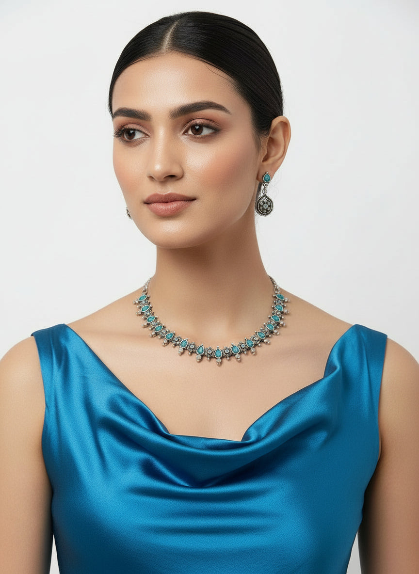 Jewellery set of silver oxidisedincludes necklace and earrings with blue stones in centre by famaza couture 