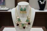 Jewellery set with necklace and earrings on a black stand