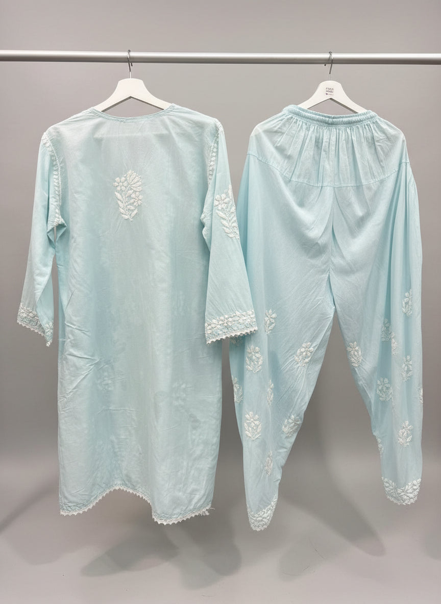 Light blue colour cotton fabric kurti and dhoti trousers back side design is showing in this image.