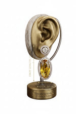 Luxury golden citrine and diamond halo earring showcased on a decorative display stand, featuring engraved specifications of 5.5 cm drop length and 2.0 cm width.