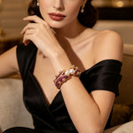 Model wearing Magenta Pearl Gold Openable Bangle on wrist — luxury bridal cuff with deep magenta-ruby gemstones, lustrous pearls, and intricate gold detailing; premium formal jewelry by Famaza Couture