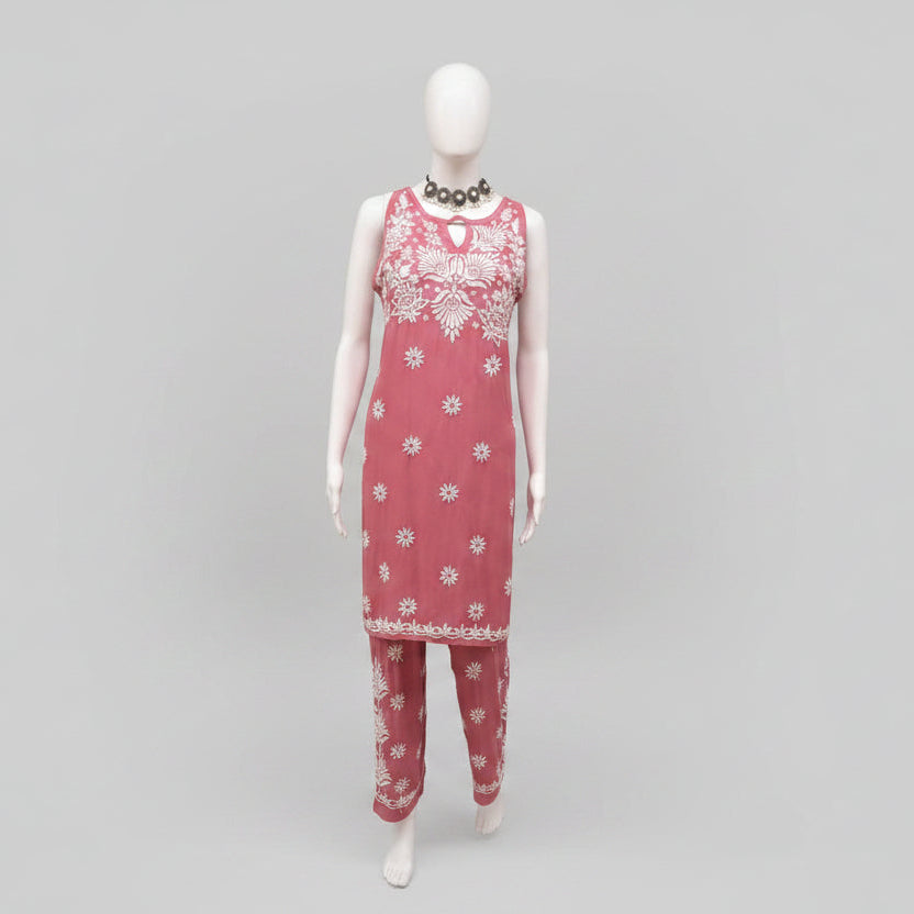 Mannequin wearing a pink dress with white floral patterns hand embroidery 2pc dress. 